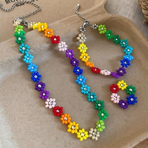 Detailed view of a colorful beaded flower jewelry set with necklace, bracelet and ring