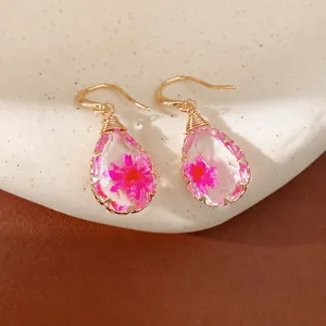 Handmade elegant resin teardrop earrings featuring pink dried flowers and gold hooks