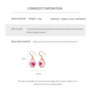 Detail of handmade resin teardrop earrings with real pink flowers, size 4cm by 1.5cm