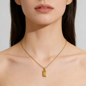 Minimalist gold titanium necklace with a rectangular yellow zircon birthstone pendant