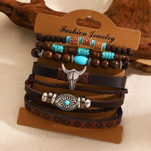 Detail of bohemian multilayer bracelet set with wood beads and silver bull head charm