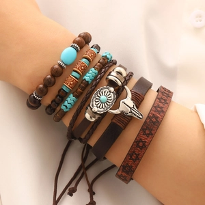 Detail of bohemian multilayer bracelet with turquoise beads and metallic ox head charm