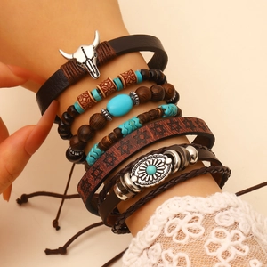 Detail of bohemian multilayer bracelet with wood beads, turquoise, and cow head pendant