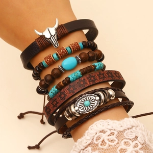 Detail of bohemian multilayer bracelet with wood beads, leather bands and bull head pendant