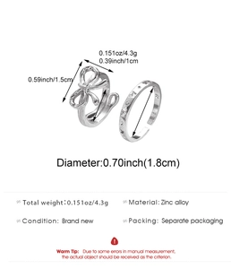 Detailed view of silver bow ring and engraved band with size and weight measurements