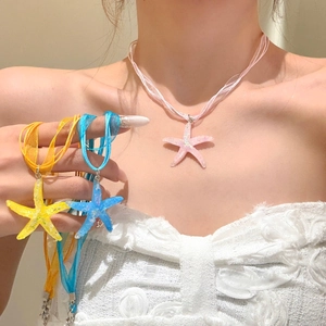 Detailed close-up view of resin starfish pendant necklaces with colorful organza ribbons