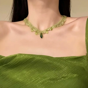 Close-up showing the intricate green beaded lace details of the vacation style necklace
