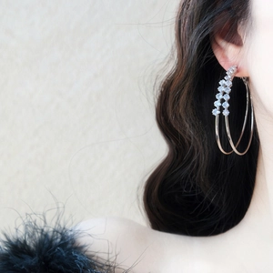Detailed view of elegant double-layer hoop earrings with sparkling zircon accents worn on ear