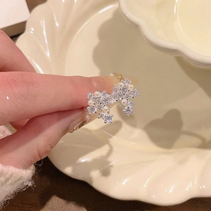 Detail view of a silver double butterfly ring with dainty pearls and sparkling crystals.