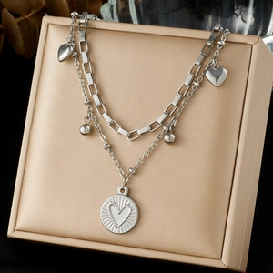 Silver layered stainless steel necklace featuring heart pendants and coin charms