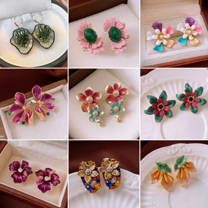 Detailed grid of vintage enamel flower earrings featuring pearls and crystal accents