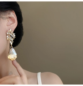 Detail shot showing vintage floral baroque earrings with amber water drop crystal tassel