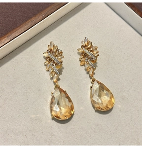 Close-up of vintage Baroque style flower and champagne teardrop crystal earrings.