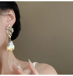 Detail shot of a vintage Baroque flower stud with a champagne pear-shaped crystal drop.