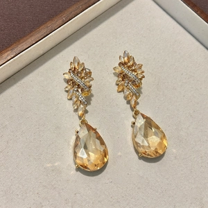 Close-up of vintage Baroque golden drop earrings with large amber teardrop crystals