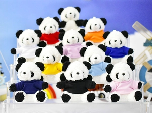 Detailed view of multiple colorful panda plush toy keychains on a tiered display stand