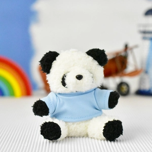 Close-up detail of a soft panda plush toy pendant wearing a miniature light blue t-shirt