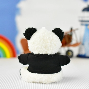 Detail view of the soft back texture of a panda plush toy wearing a black shirt