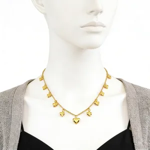 Gold-toned geometric heart pendant necklace on a model with minimalist styling