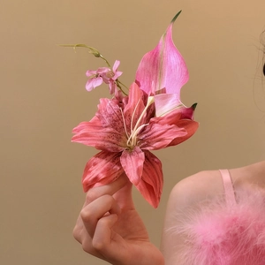 Detailed close-up of an elegant oversized pink lily flower hair clip with delicate floral accents