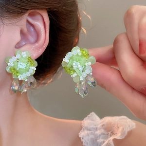 Green handmade beaded floral earrings with dangling iridescent crystal teardrops
