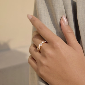 Close-up of gold-plated stainless steel ring with marquise and round cubic zirconia.