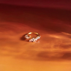 Detailed macro shot of a gold stainless steel open ring with pear-shaped zirconia stones