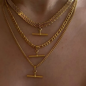 Layered gold stainless steel curb and figaro chain necklaces with T-bar pendants