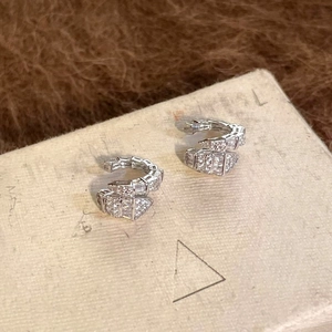 Detailed view of silver snake ear cuffs with sparkling cubic zirconia accents.