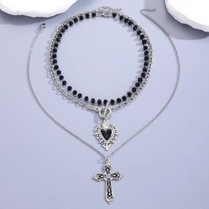 Detail view of gothic triple-layered necklace with silver chains and black cross pendant