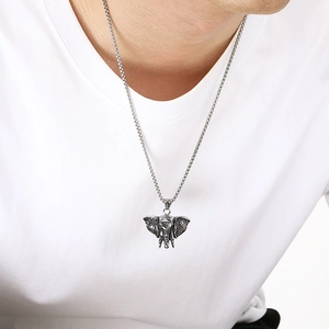 Detail shot of a vintage distressed elephant pendant necklace for men in hip hop style