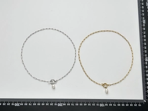 Detail of gold and silver paperclip necklaces with OT toggle clasp and baroque pearls