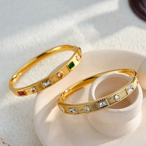 Elegant gold stainless steel bangles with colorful inlaid cubic zirconia crystals for women.