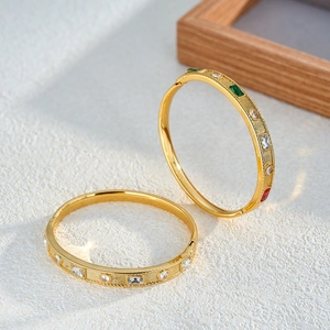 Minimalist stainless steel gold bangles featuring geometric multi-colored zircon and rhinestone inlay