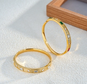 Macro view of gold-plated stainless steel bangles inlaid with colorful geometric zirconia stones