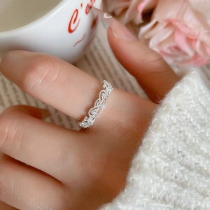 Delicate silver hollow geometric open ring with sparkling cubic zirconia shown on finger