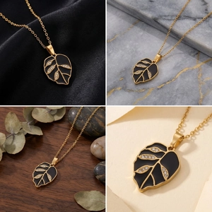 Detailed close-up of gold leaf pendant necklace with black enamel and crystals on multiple backgrounds