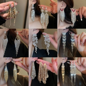 Macro showcase of nine elegant tassel drop earrings with sparkling cubic zirconia crystals