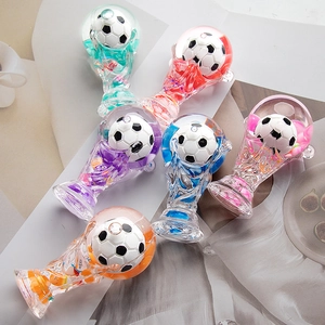 Macro shot of liquid-filled World Cup trophy keychains with colorful glitters and floating balls