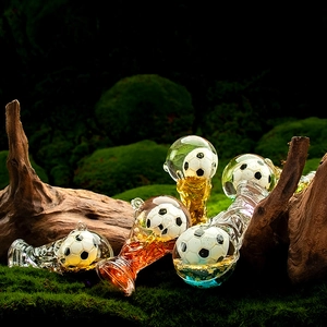 Macro shot of liquid sand acrylic trophy keychains with miniature football inside