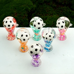 Set of six colorful liquid sand trophy keychains in a vibrant triangular arrangement
