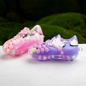 Creative liquid sand acrylic sneaker keychains with colorful pompom fillings on marble