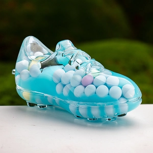 Macro view of a creative soccer shoe desk ornament with blue acrylic and colorful beads