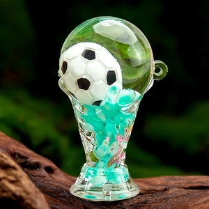 Acrylic trophy keychain with floating football and blue beads on wooden stand