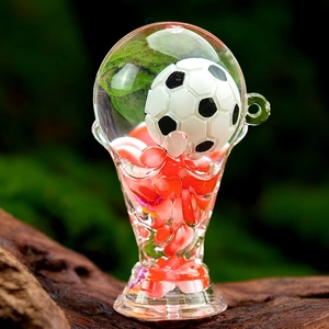 Detailed close-up of acrylic trophy keychain with floating beads and miniature soccer ball