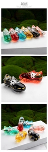 Detailed view of colorful soccer shoe sand bottles with miniature floating footballs