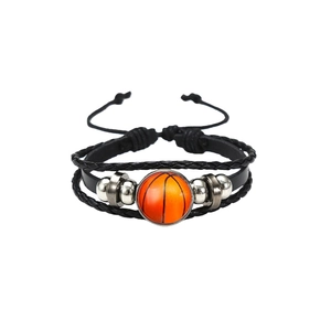 Detail of multi-layer leather bracelet featuring a basketball motif glass cabochon focal point