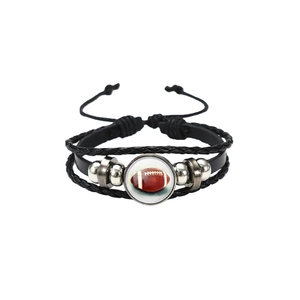 Detail of multi-layer braided leather bracelet with American football glass charm