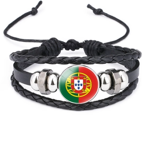 Detail of woven black leather bracelet featuring the Portuguese flag glass cabochon