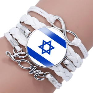 Detail of multi-layer white leather bracelet featuring Israel flag charm and Love symbol